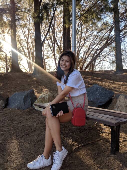 ANU student  Pavana Suwanmuk with the diary her mother gave her detailing her mother's early life in Australia after moving here from Thailand. Photo: Supplied