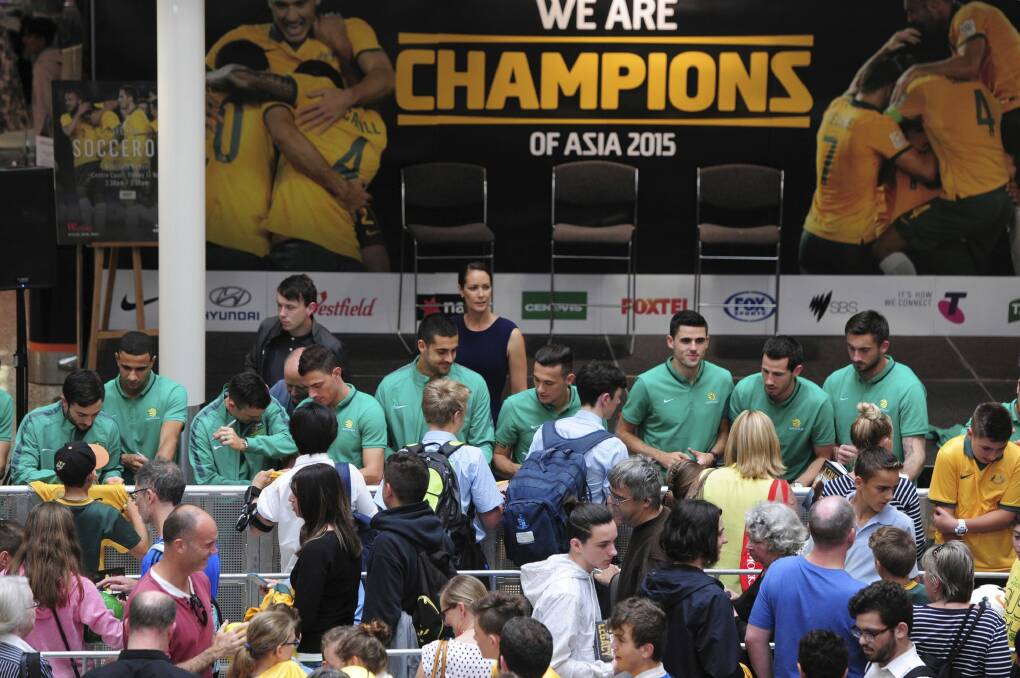 The Socceroos hold a meet and greet autograph session at centre
stage, Westfield Woden, on Friday.
 Photo: Graham Tidy
