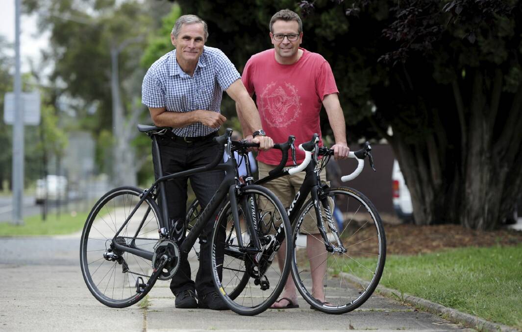 Taking part in a Paceline charity bike ride from Canberra to Melbourne
are Bruce Williams, left, and Steve Quinn. Photo: Graham Tidy
