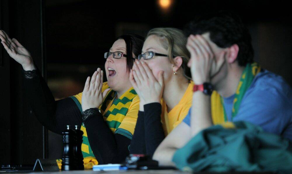Jess Thompson, Joanna and Brendan Belcher react to Australia's defeat. Photo: Graham Tidy