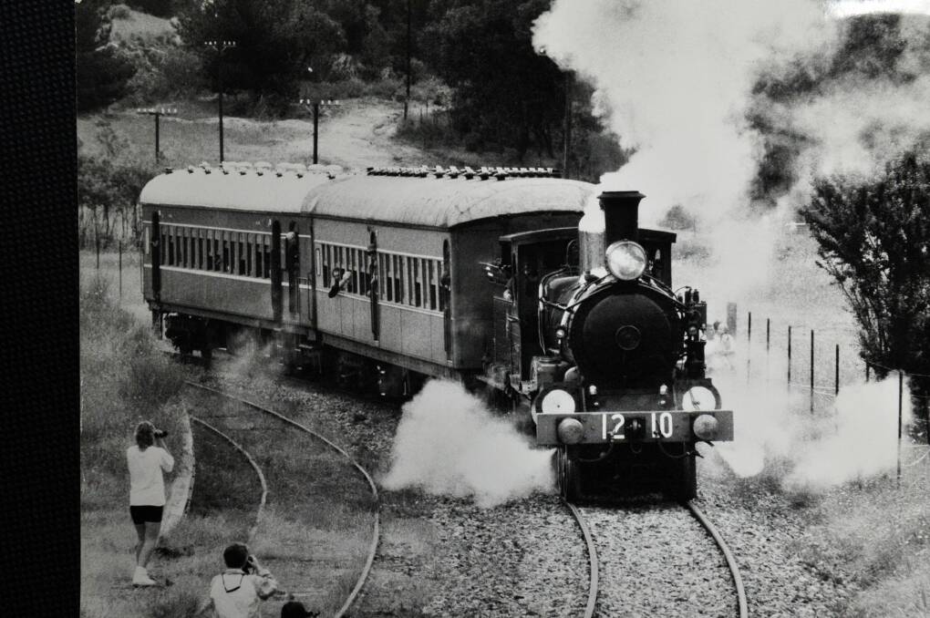 Train enthusiasts take photos of the 1210, pride of the Canberra Rail Museum's fleet, leaves the Tuggeranong siding in December 1992. Photo: Canberra Times archives