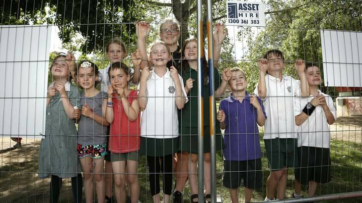 Children from Duffy Primary School and Pre School gather to watch one of the ten classroom modules to be lifted into place at Duffy Primary School as part of a $2.8 million upgrade at the school. Photo: Jeffrey Chan