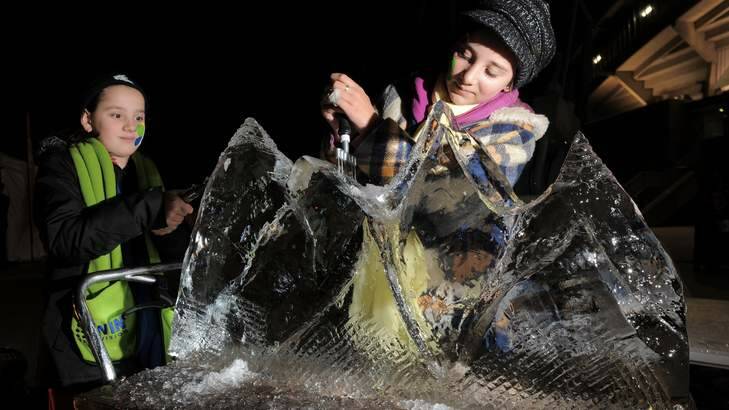 Sisters, Caitlin Bonadei, 10, and Stephanie Bonadei, 12, have a go at ice sculpturing. Photo: Graham Tidy