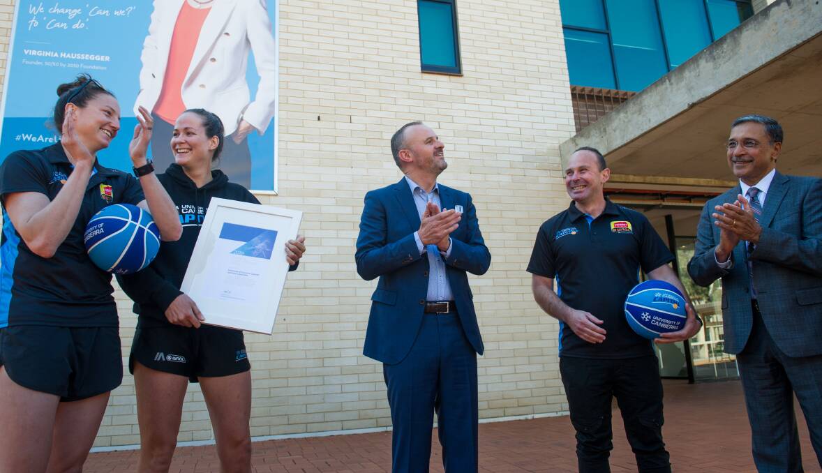 Chief Minister Andrew Barr at the University of Canberra announcing the Capitals are Citizens of the Year. With him are players Kelsey Griffin and Keely Froling, coach Paul Gorris and UC vice-chancellor Deep Saini. Photo: Elesa Kurtz