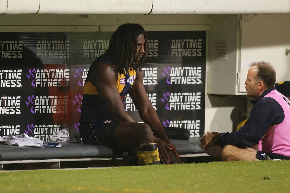 A dejected Nic Naitanui on the Eagles bench on Friday night. Photo: Getty Images/AFL Media
