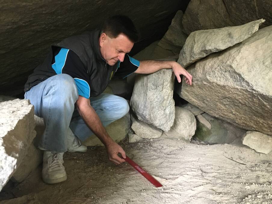 Greg Shaw measures the mystery left footprint with a ruler. Photo: Tim the Yowie Man