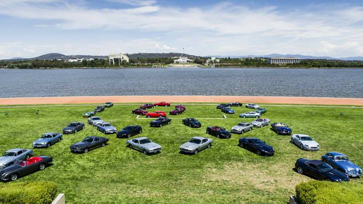 The Aston Martin Club's annual meeting, this year in Canberra, display their cars at Rond Terrace in the shapes of the club logo (M) and 100 for the centenary. Photo: Rohan Thomson