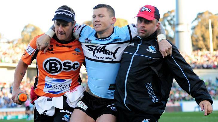 Sharks player Todd Carney leaves the field with an ankle injury. Photo: Melissa Adams