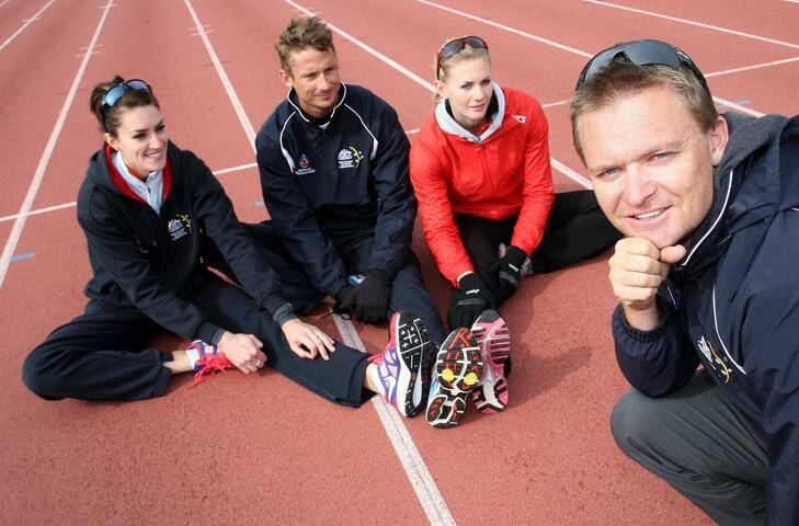 Runners and training buddies (from left) Lauren Boden, Brendan Cole and Melissa Breen with coach Matt Beckenham stretch before training at the AIS Athletics Track. Photo: Jeffrey Chan