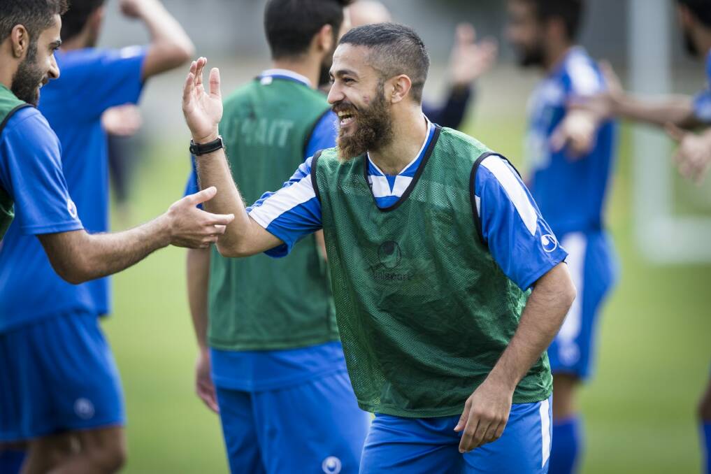 Kuwait midfielder Aziz Mashaan in good spirits with his teammates at a training camp at the AIS on Sunday. Photo: Matt Bedford