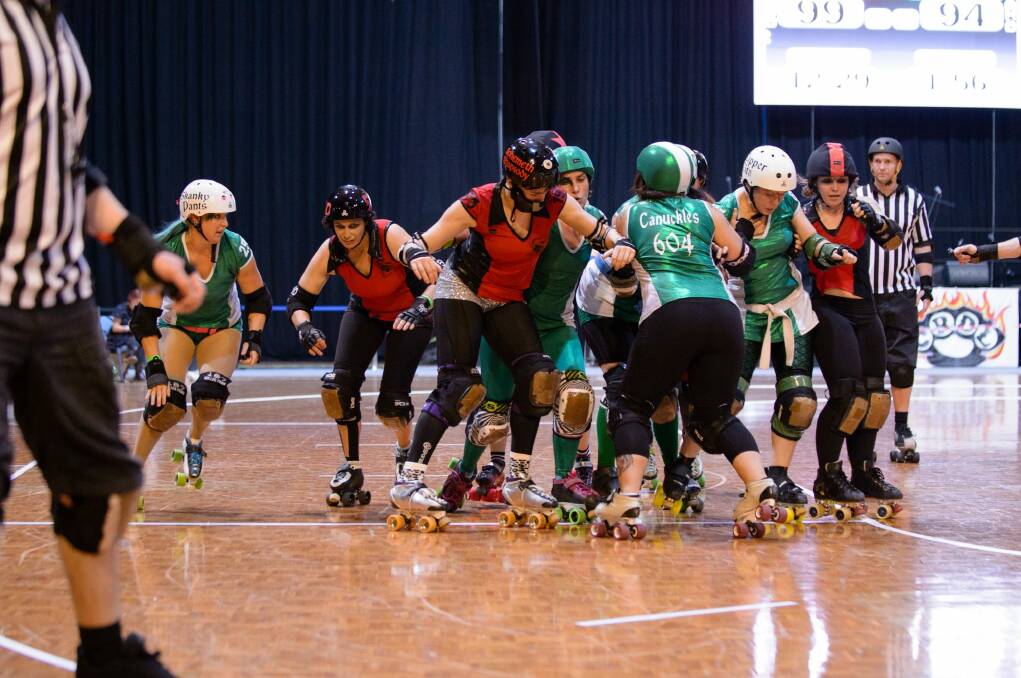 The Red Bellied Black Hearts taking on the Surly Griffins in the 2014 grand final of the Canberra Roller Derby League, with Bohemeth Rhapsody in the centre.  Photo: Brett Sargeant