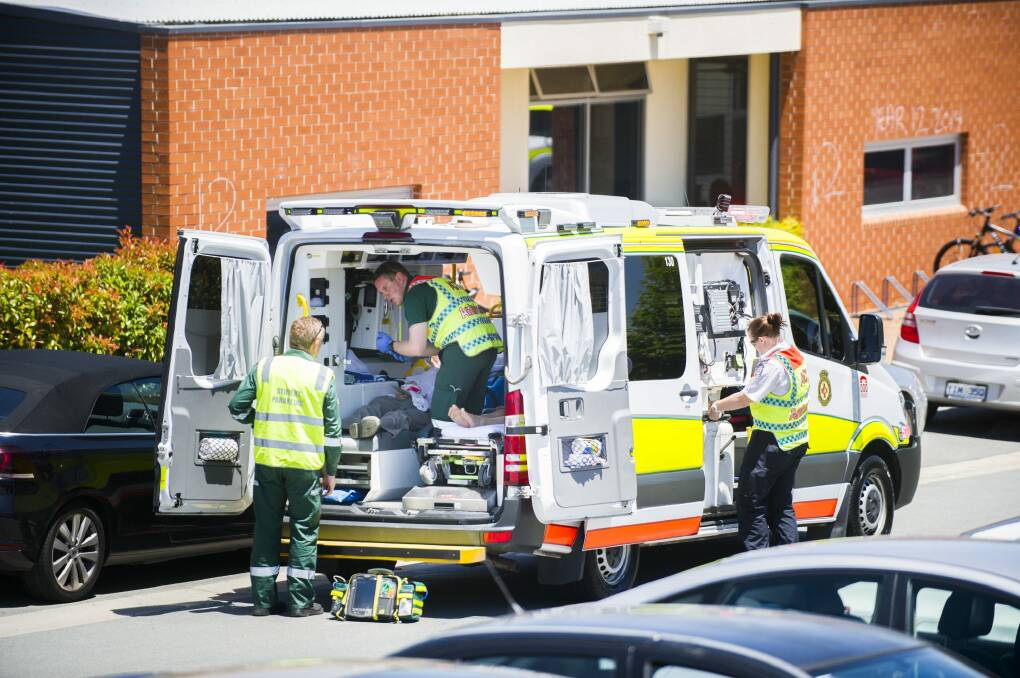 Paramedics treat students and teachers after an explosion between sugar and sulphuric acid in a year 9 class at Burgman Anglican School in Gungahlin. Photo: Rohan Thomson