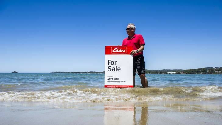 Elders Batemans Bay principal, Greig McFarlane, with a for sale sign at the small piece of land he is selling in Batemans Bay. Photo: Rohan Thomson