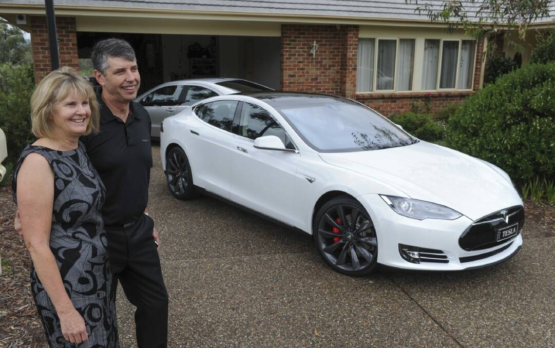 Michael Thompson and his wife Margaret, of Tuggeranong, own two electric vehicles, a Holden Volt and a Tesla P85d. (front). Photo: Graham Tidy