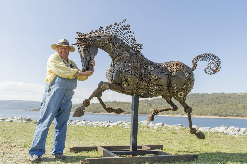 Artist Andrew Whitehead with his latest work, an iron horse titled Freedom Run, which he has entered in Jindabyne's Lake Light exhibition. Photo: Jay Cronan