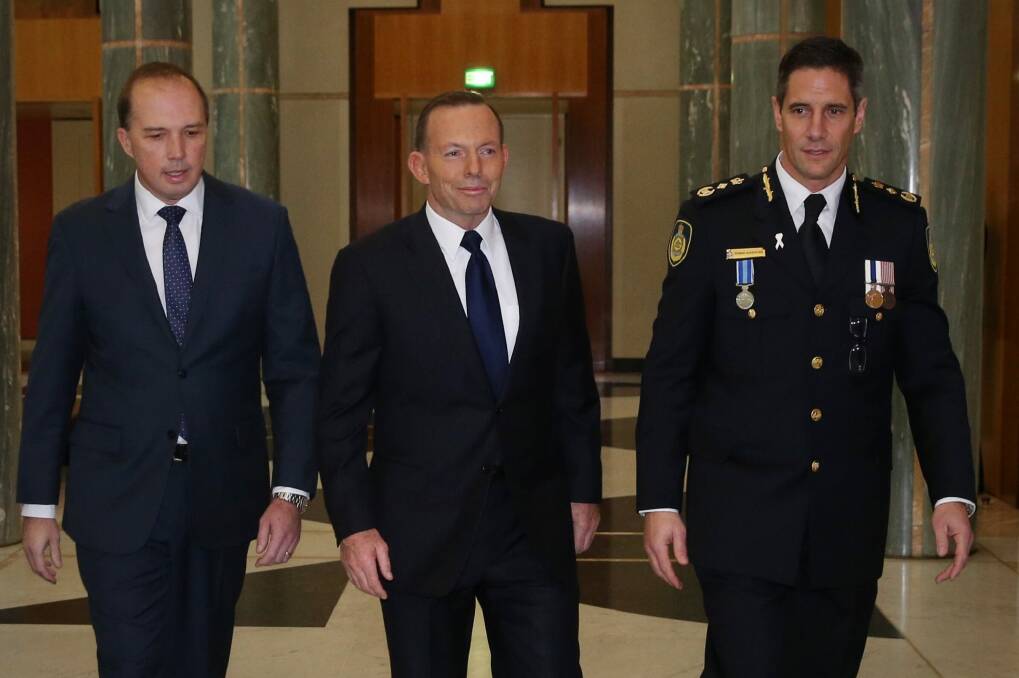 Prime Minister Tony Abbott and Immigration Minister Peter Dutton, left, at the swearing in ceremony of the inaugural Border Force Commissioner Roman Quaedvlieg, right. Photo: Andrew Meares