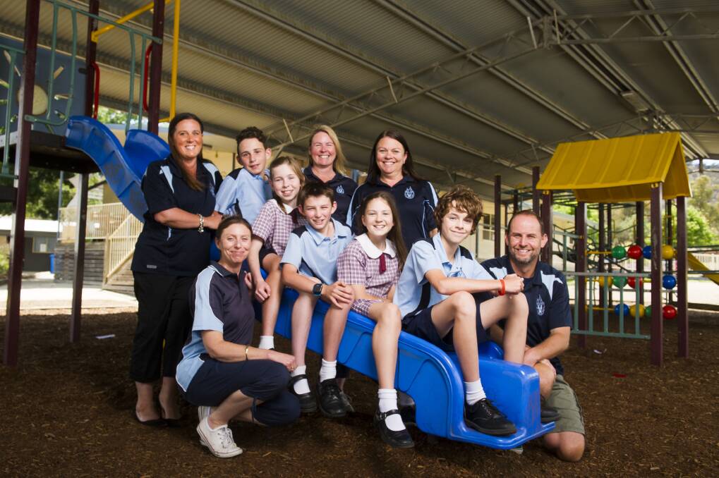 Roll call: Tracy Mowlam, Belinda Breen, Annie McArthur, Katherine Austin, and Ben Sweeney, (Kids from left) Nathaniel Mowlam, Lindsay McArthur, Hayden Breen, Amelia Austin, and Rhys Sweeney at St Clares of Assisi Primary School. Photo: Dion Georgopoulos