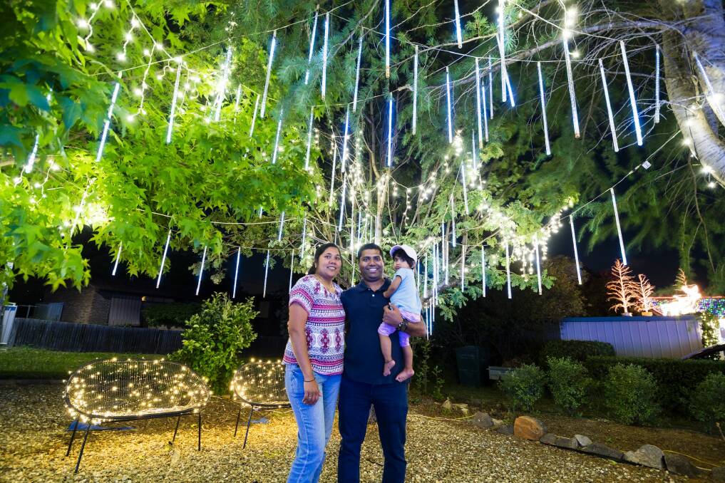 Jessica and  Antony Michaelson with one-year-old  Sophia under the famous Christmas lights in Bissenberger Crescent in Kambah. Photo: Dion Georgopoulos