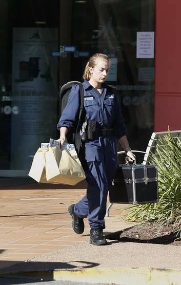 An ACT Policing forensic officer leaves the Canberra International Sports and Aquatic Centre following the death of a girl on Saturday morning. Photo: Jeffrey Chan