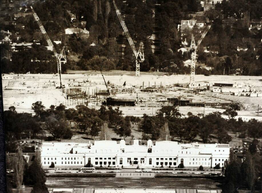 The massive new Parliament House under construction with the old parliament building in the foreground. Photo: Peter Rae