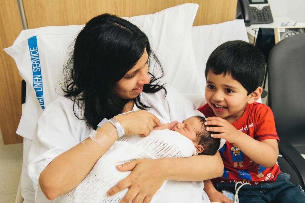 Erandi Kulasekera with her two sons, Methuka Mohottala, 3, and her two-day-old unnamed newborn at the Canberra Hospital. Photo: Rohan Thomson
