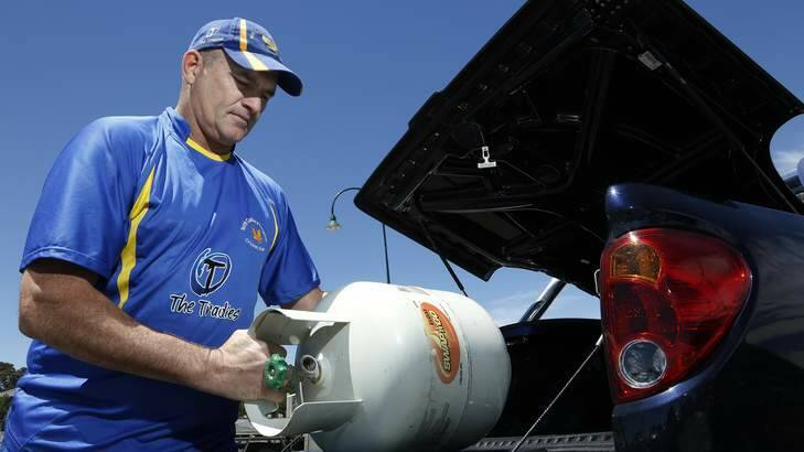 North Canberra and Gungahlin Cricket Club operations manager Steve Moore removes a gas bottle from the club. Photo: Jeffrey Chan