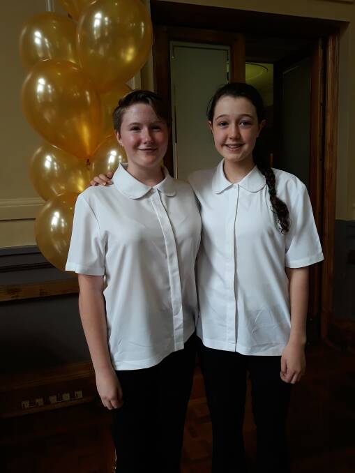 Woden Valley Youth Choir members Evangeline Osborne, 13, and Hannah Harper, 15, at the Canberra Gold Awards ceremony where the choir was recognised for 50 years of service to the national capital. Photo: Megan Doherty