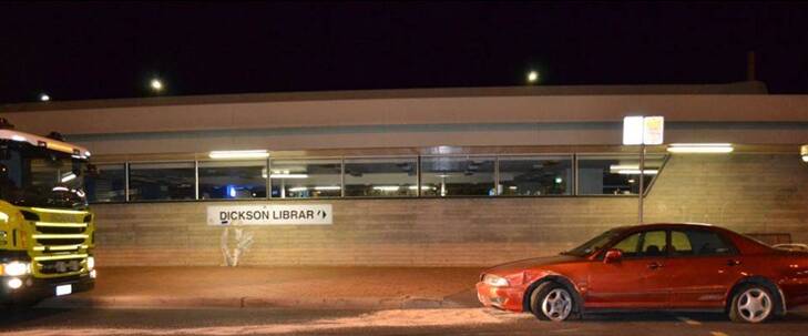 The car mounted a curb, knocked down a street sign and crashed into the library. Photo: Supplied