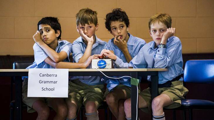 Canberra Grammar Primary school students, Nick Barnard, James Rogers, Leo Barnard, and James Phillips, try to think of an answer. Photo: Rohan Thomson