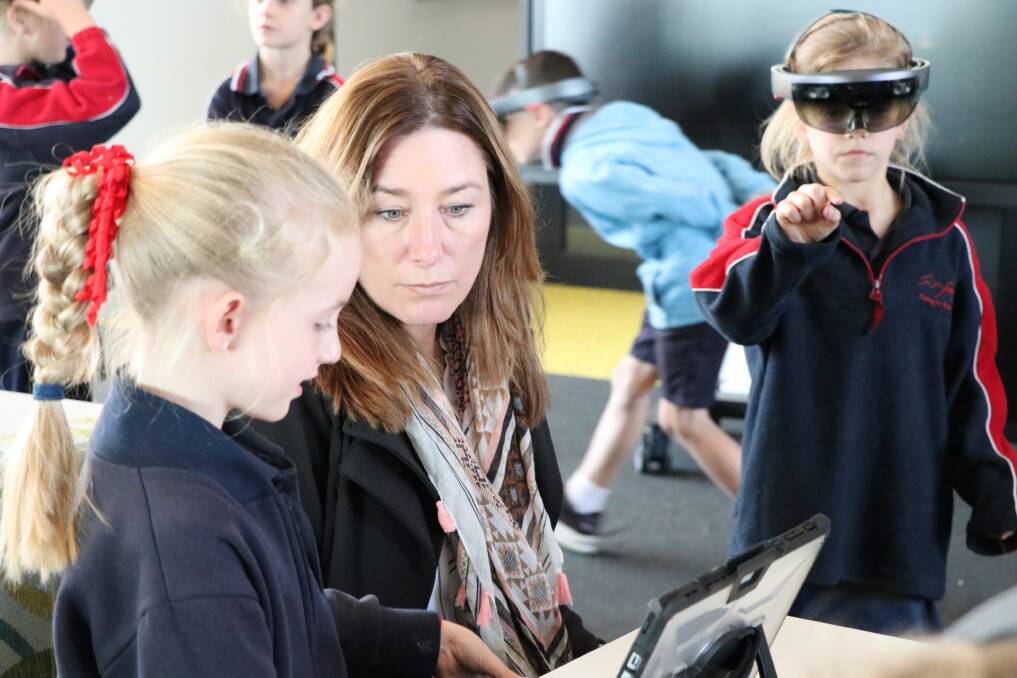 Education Minister Yvette Berry (centre) visits students at the first of the two STEM hubs, based at Caroline Chisholm School. Photo: Supplied.