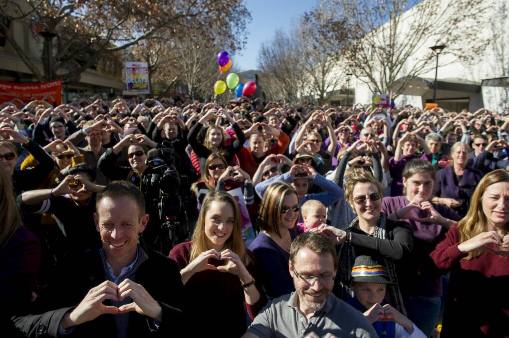 Canberrans, including Samantha and Hayley Wilson (third and fifth from left), at the Love in Canberra rally for marriage equality. Photo: Jay Cronan