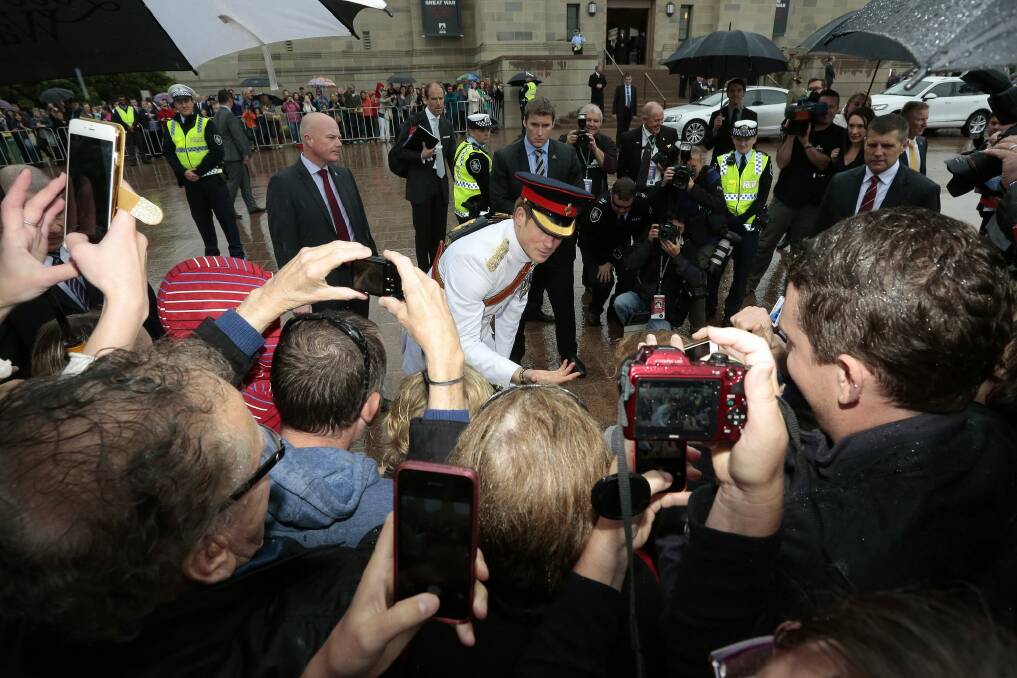  Prince Harry meets the crowd who braved wet weather outside the Australian War Memorial. Photo: Jeffrey Chan