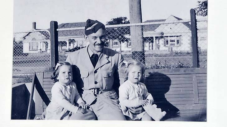 A posthumous Silver Star Medal awarded at a ceremony at the Australian War Memorial to the family of Flying Officer Edward Mobsby. A photograph of him with his twin daughters, Jenny and Rae. Photo: Graham Tidy