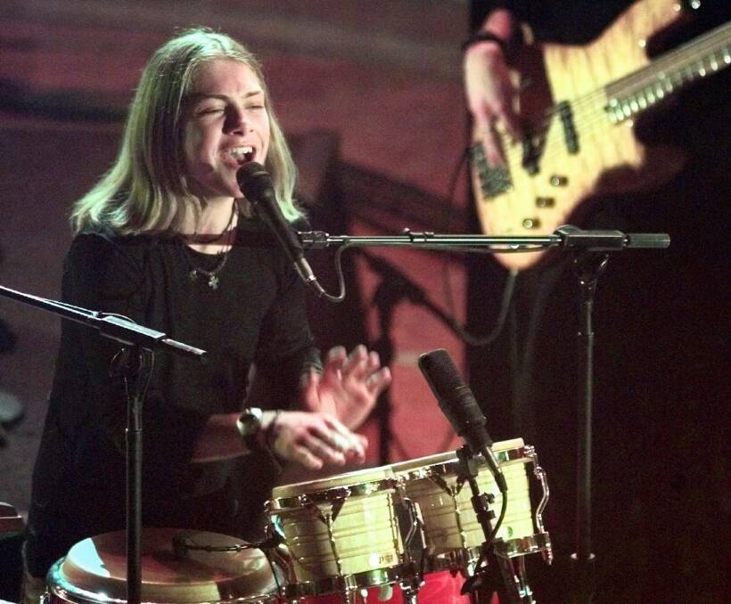 Taylor Hanson plays the bongo drums on stage at the 40th annual Grammy Awards in 1998. Photo: Mark Lennihan