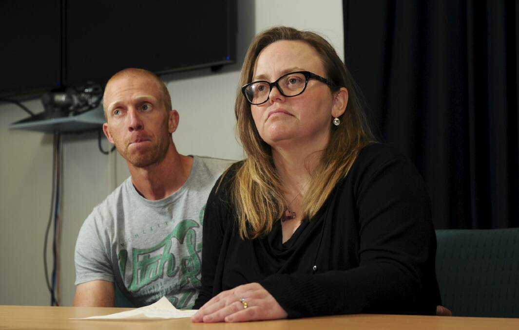Jenny Heddle, the wife of missing Chisholm man Stuart Heddle,
makes a public plea at the Woden Police Station. At left is Stuart's
brother Ian. Photo: Graham Tidy