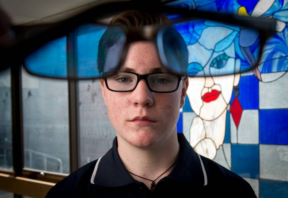 Silas Dewney, 14, says his coloured glasses have helped with his dyslexia.  Photo: Penny Stephens