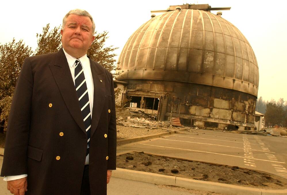 Then vice-chancellor of the ANU, Ian Chubb, stands beside the main 74inch telescope dome after the fires. Photo: Martin Jones