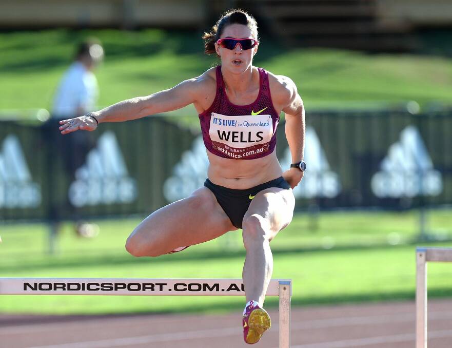Canberra athlete Lauren Wells on her way to winning the women's 400m hurdles at the Australian Athletics Championships in Brisbane on Sunday. Photo: Getty Images