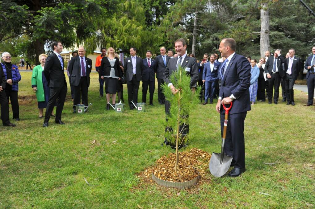 Prime Minister Tony Abbott plants a sapling with Ian Irving, chief executive for Australia, Northrop Grumman, at the launch of the Soldier On, Hand Up program. Photo: Jay Cronan 