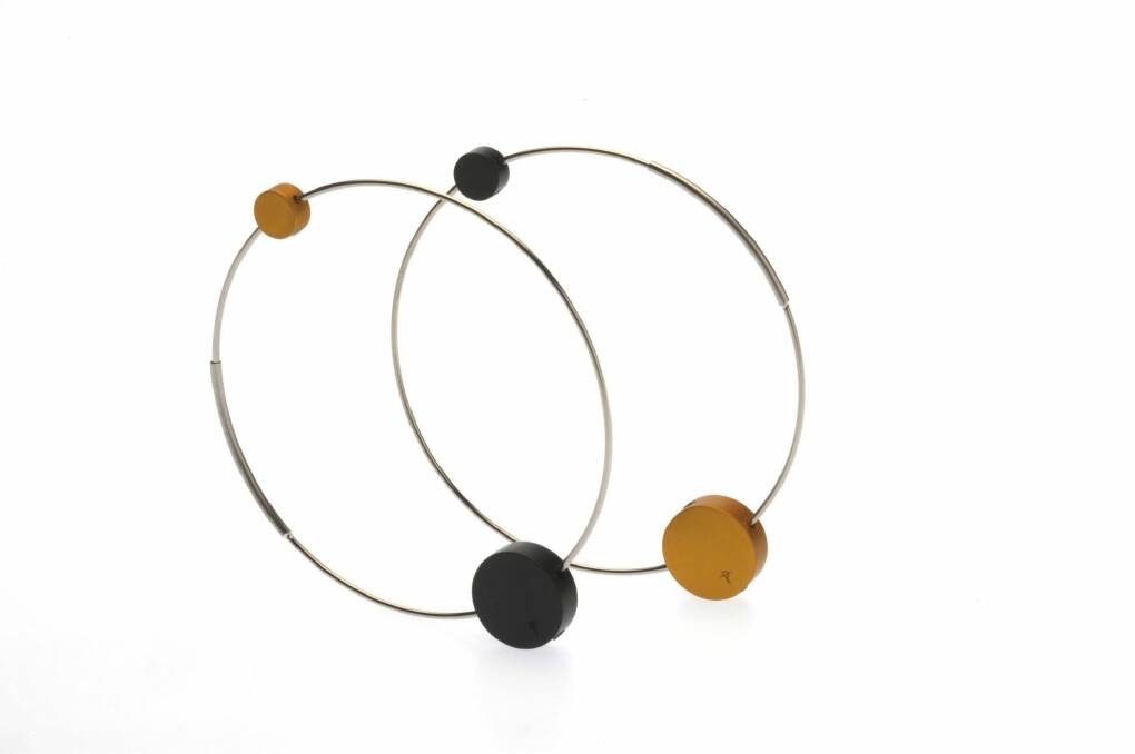 Disc earrings by Phoebe Porter made from yellow and black aluminium and stainless steel. Photo: Supplied