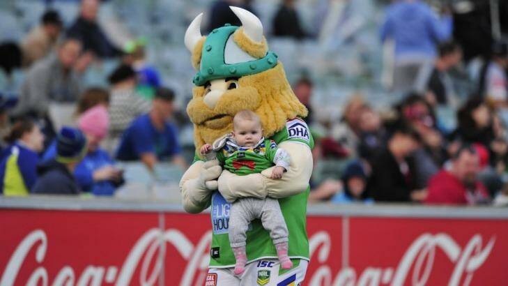 Canberra Raiders mascot Victor the Viking holds Lily Arthur, 8 months, of Banks. Photo: Melissa Adams