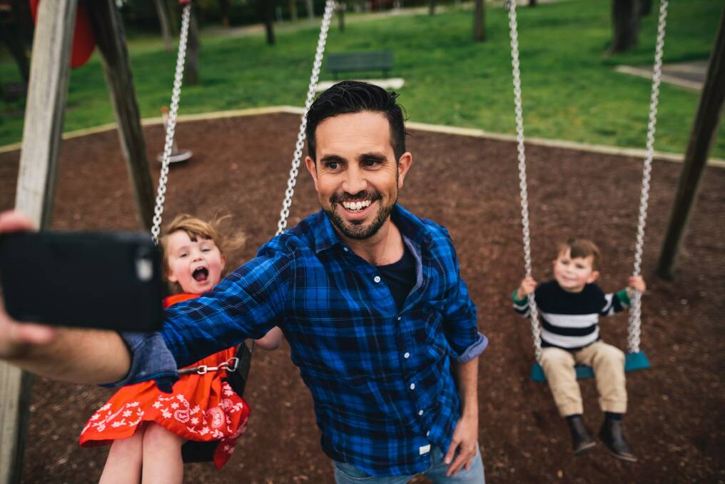 Lachlan Searle with his children Tom, 4, and Lottie, 3, at their local park in Deakin. Photo: Rohan Thomson
