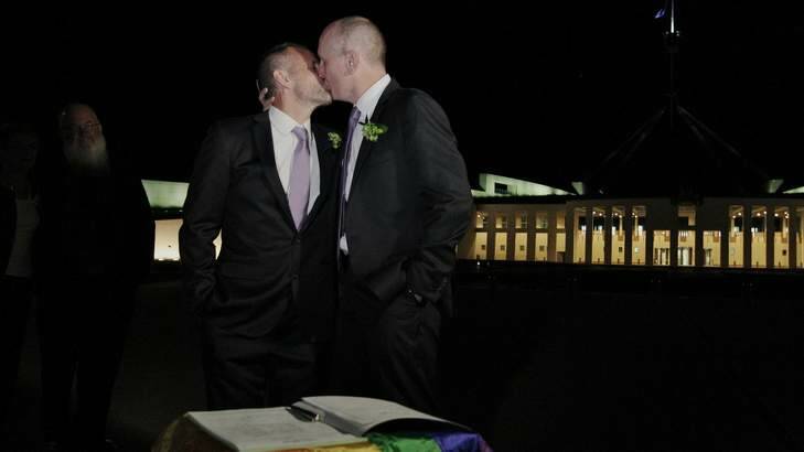 Dennis Liddelow and Stephen Dawson kiss after getting married shortly after midnight, in front of Parliament House on December 7.