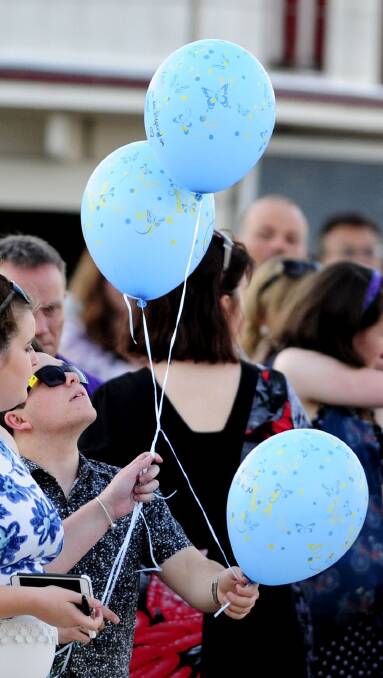 Cathy's son, Keane about to release three balloons in memory of his mother. Photo: Melissa Adams