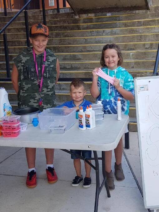 Selling the slime at the Southside Farmers Market, eight-year-old Una Skein with brother Kai, 12, and a young friend. Photo: Supplied