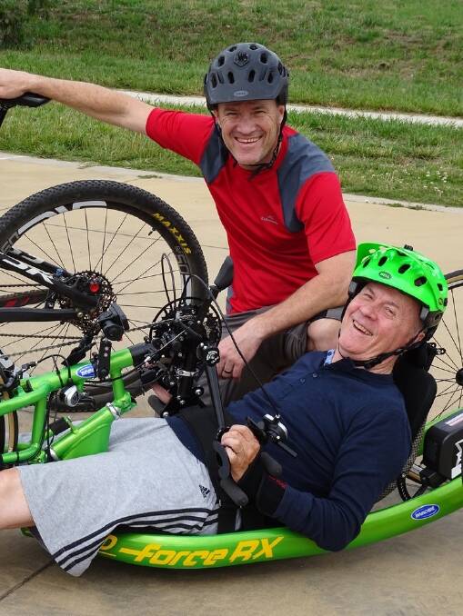 Andrew Kerec and his dad Lud with Lud's hand-driven  cycle.Lud did the first 10km of the journey alongside Andrew. Photo: Supplied