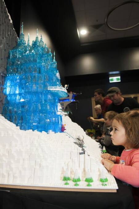 Natalia Rosa, 3, of Deakin, surveys Elsa in her Frozen Lego castle.  Photo: Elesa Kurtz