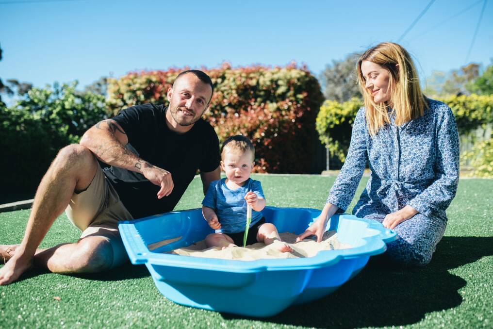 Josh Hodgson at home with his wife Kirby and son George. Photo: Rohan Thomson