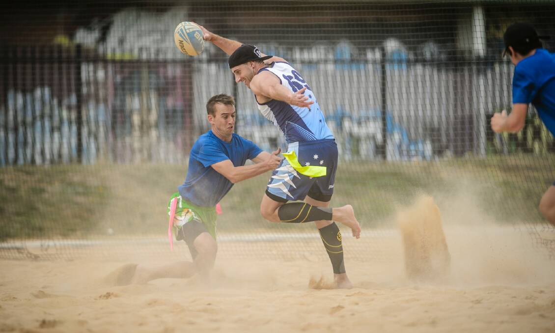 Players compete in the Tag Rugby ACT Beach Bash in Lyneham on Saturday morning.  Photo: Sitthixay Ditthavong