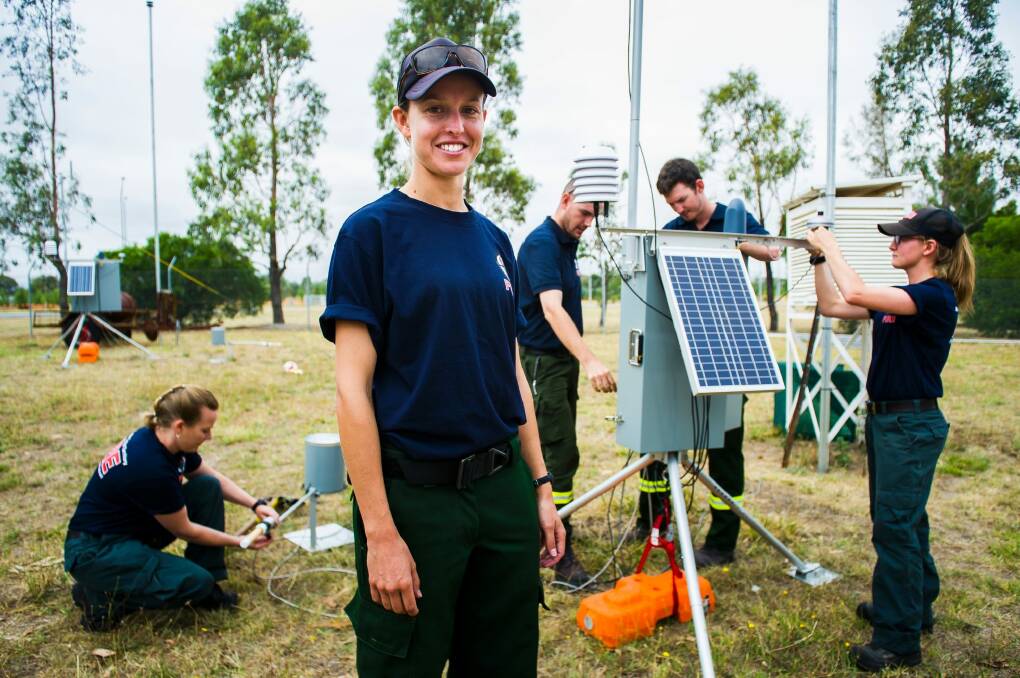 Fire management unit leading hand Amanda Johnson with fire management crew familiarising themselves with the weather stations, which have been bought from Canada. Photo: Elesa Kurtz